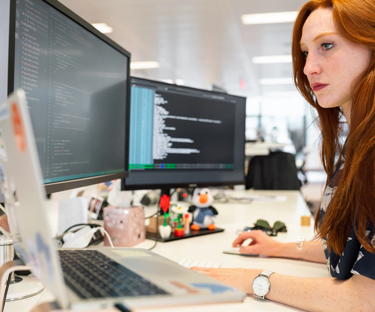 A woman working at a computer in a bright office